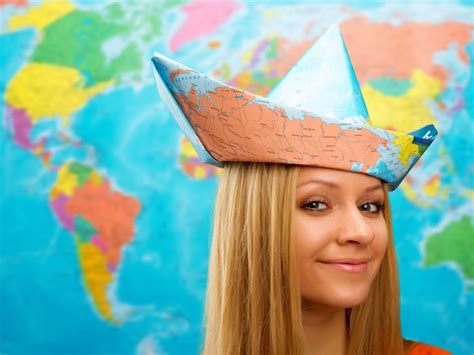 Premium Photo | Cute traveler girl in a hat from map