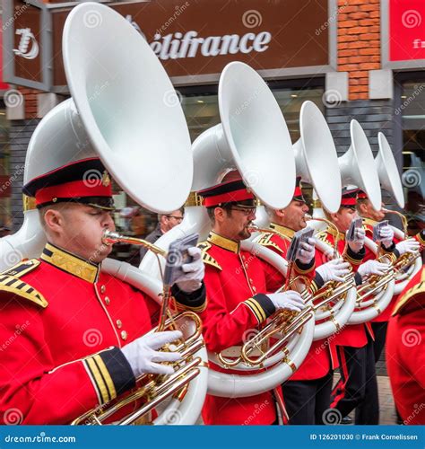 Five Sousaphone Blazers in Beautiful Red Uniforms Lined Up Marching in the City. Editorial Image ...