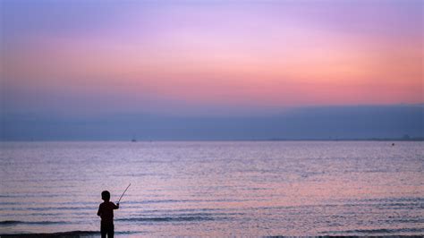 the fisherman on sunset beach 4k HD Wallpaper