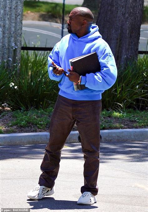 Kanye West dons his new Yeezy Foam Runners and a bright blue hoodie ...