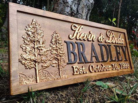 a wooden sign that is on the side of a hill in front of some trees