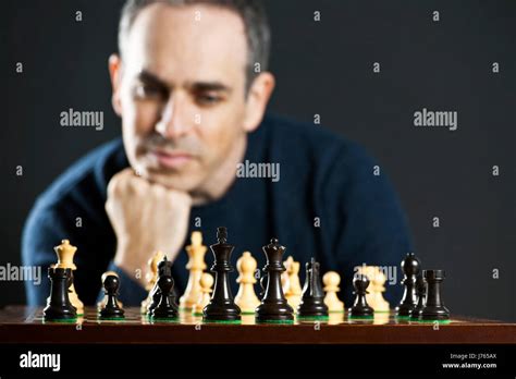 men man game tournament play playing plays played chess chessboard pieces hand Stock Photo - Alamy