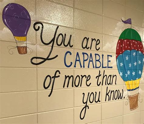 a sign on the wall that says you are capable of more than you know with hot air balloons