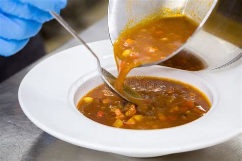 Pouring Soup In A Plate On Served Table With A Ladle Stock Photo - Image of freshness, green ...