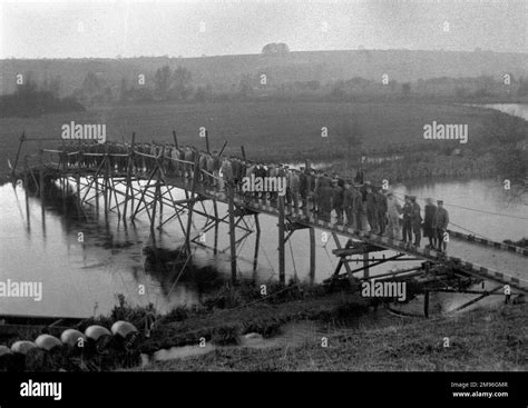 A large number of soldiers standing on a bridge across the river at Tidworth, Wiltshire Stock ...