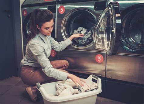 Beautiful woman doing laundry at laundromat shop. | T & L EQUIPMENT SALES CO., INC. | Commercial ...