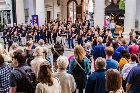 Watch as singing flash mob belts out ‘You’ll Never Walk Alone’ in Guildford - Surrey Live