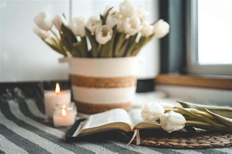 Premium Photo | Open Bible with flowers and candles in a cozy home ...