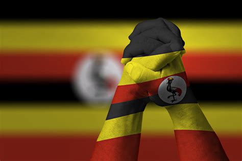 man-clasped-hands-patterned-uganda-flag | Uganda flag, Uganda, Independence day history