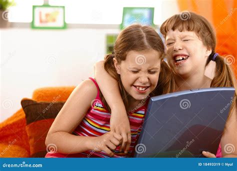 Cute Girl Friends Laughing At Laptop Royalty Free Stock Images - Image: 18493319