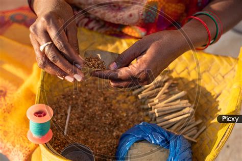 Image of Indian Rural Woman Making Beedi for her livelihood in ...