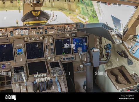 A view of cockpit of a 747-8F aircraft with captain hat on the avionics Stock Photo - Alamy