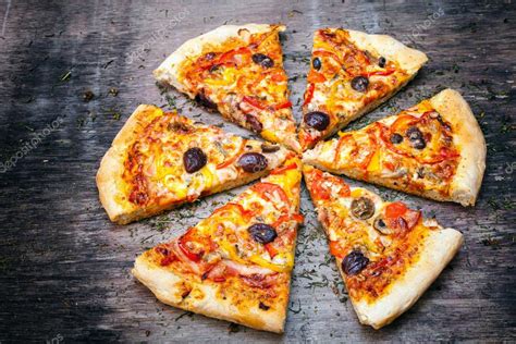 Pizza cut into slices Stock Photo by ©blackboard1965G 49539389