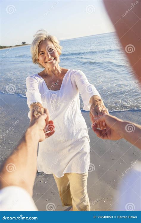 Happy Senior Couple Dancing Holding Hands on a Tropical Beach Stock ...