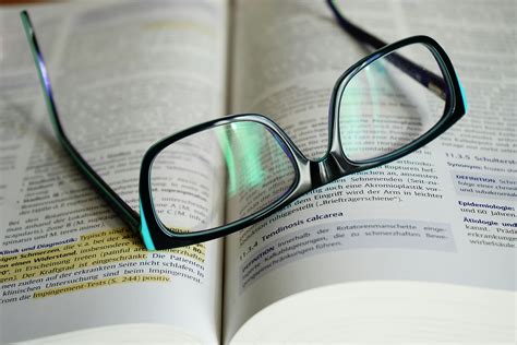 Free stock photo of book, book pages, eyeglasses