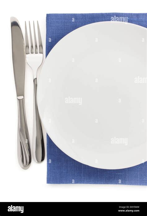 plate, knife and fork at napkin on white background Stock Photo - Alamy