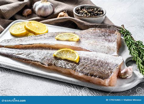 Fresh Raw Hake Fish Fillet With Pepper And Lemon. White Background. Top ...