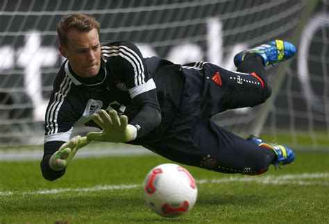 The goalkeeper of Bayern Manuel Neuer is catching a ball wallpapers and ...