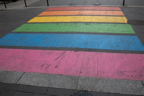 Premium Photo | Town street pedestrian crossing paint in colors rainbow flag sign to sex ...