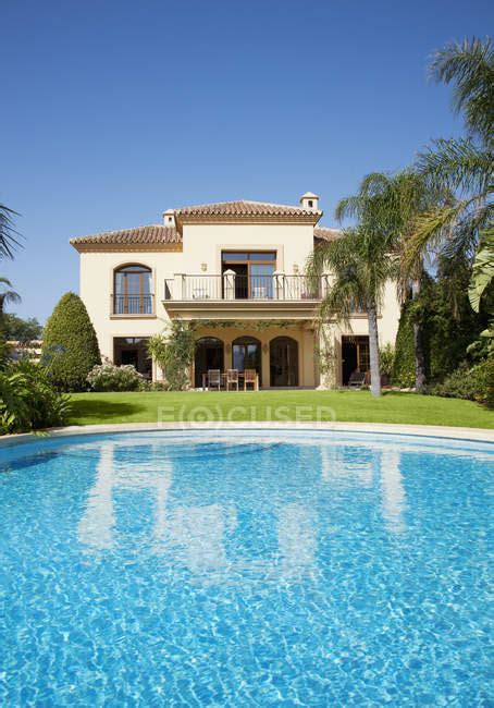 Luxury swimming pool and Spanish villa — vertical, estate - Stock Photo ...