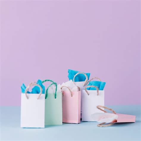 Free Photo | Many multicolored shopping paper bags in front of pink background