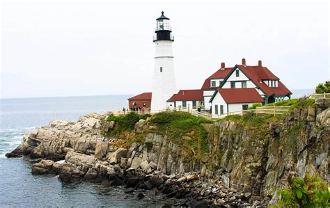 a light house sitting on top of a cliff next to the ocean