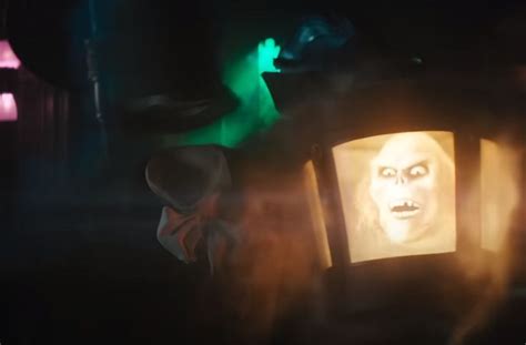 an old fashioned lantern lit up in the dark with a creepy face painted ...