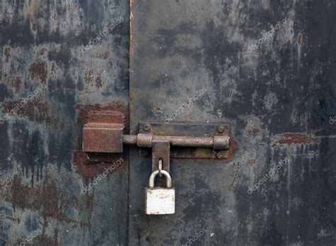 Old rusty locked metal gate. Stock Photo by ©pavelalexeev 83311380