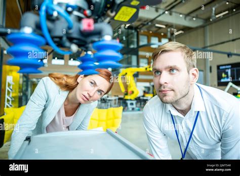 Engineers inspect industrial robot Stock Photo - Alamy