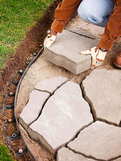 a person is placing bricks in the ground