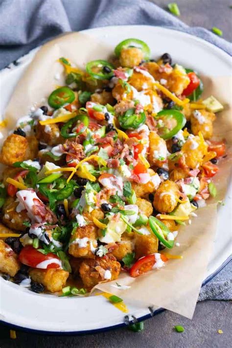 Totchos are tater tot nachos piled with classic Mexican ingredients. Everyone loves this easy ...