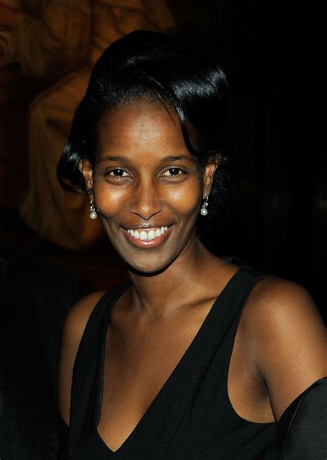 a woman in a black dress smiling at the camera