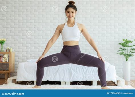 Athletic Asian Woman Practice Yoga Sumo Squat Pose To Meditation in Bedroom Stock Image - Image ...