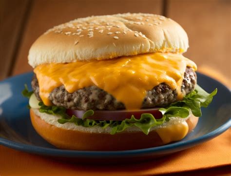 Premium AI Image | Delicious hamburger with melt cheese on a wood ...