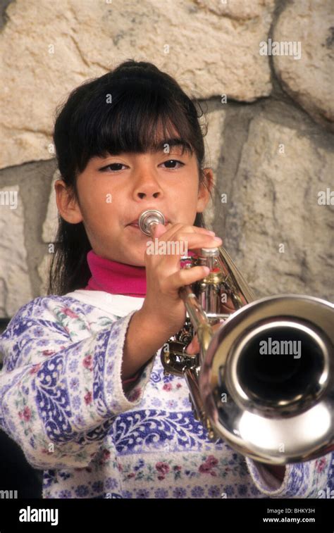 Hispanic girl play trumpet music instrument sound tune tone blow lip ...