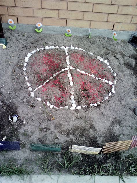 Peace symbol in garden (white rocks) and red craft rocks | Red crafts ...