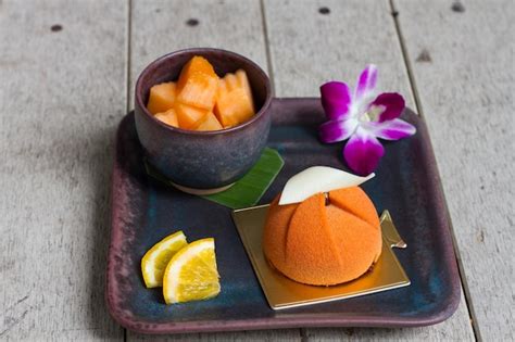 Premium Photo | Close-up of dessert with fruit on tray at table