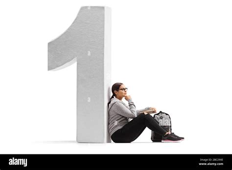 Female student sitting and leaning on a big number one isolated on white background Stock Photo ...