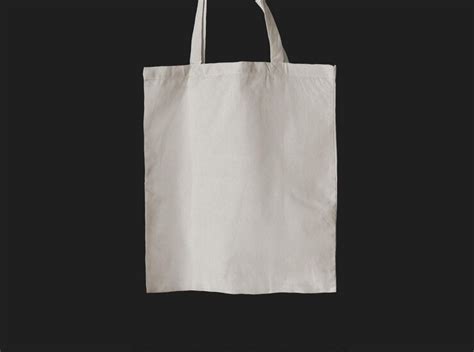 Free Photo | Plain white tote bag hanging on black background