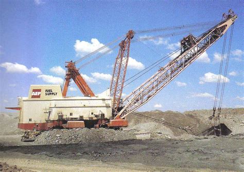 there is a large crane that is in the middle of some dirt and rock field