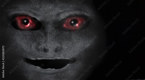 Scary creature with red eyes. Portrait of an alien or demon. A vision ...