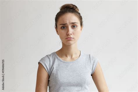 Human facial expressions, emotions, feelings and attitude. Unhappy sad young woman with hair ...