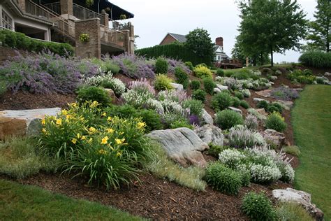 Don't know what to do with that hillside? Boulders, along with beautiful shrubs and perennials ...