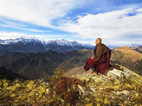 HD wallpaper: monk sitting on the cliff on the mountain under the blue ...