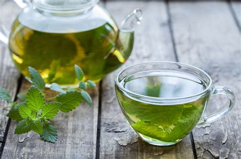 Close up of a glass teapot full of peppermint tea