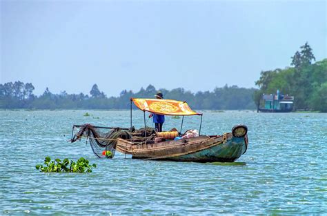 Fishing in the Mekong Delta Photograph by Carolyn Derstine - Fine Art America