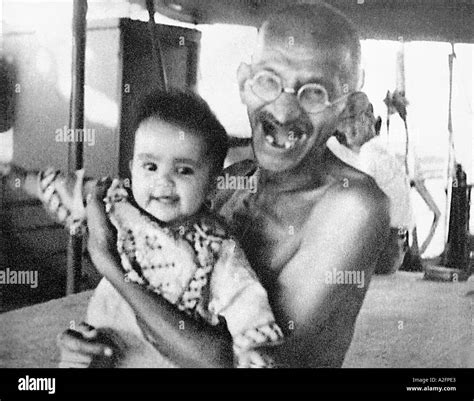 Mahatma Gandhi laughing playing with a child during his voyage on SS Stock Photo: 3431138 - Alamy