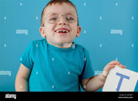 Cute little boy with letter on blue background. Child learning a letters. Alphabet Stock Photo ...