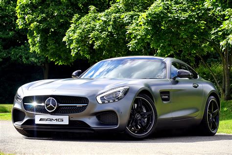 Silver Mercedes-benz Amg Gt Coupe Parked Beside Green Leaf Tree · Free Stock Photo