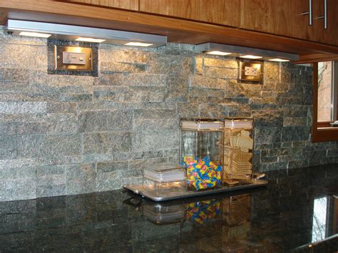 A stacked stone backsplash is a nice contrast with granite counter tops ...